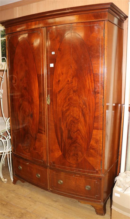 A George III style banded mahogany two door bowfronted wardrobe W.138cm